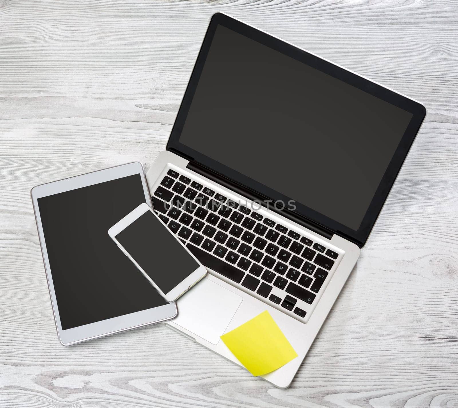 View of a Laptop in high definition with tablet and mobile on a wood background