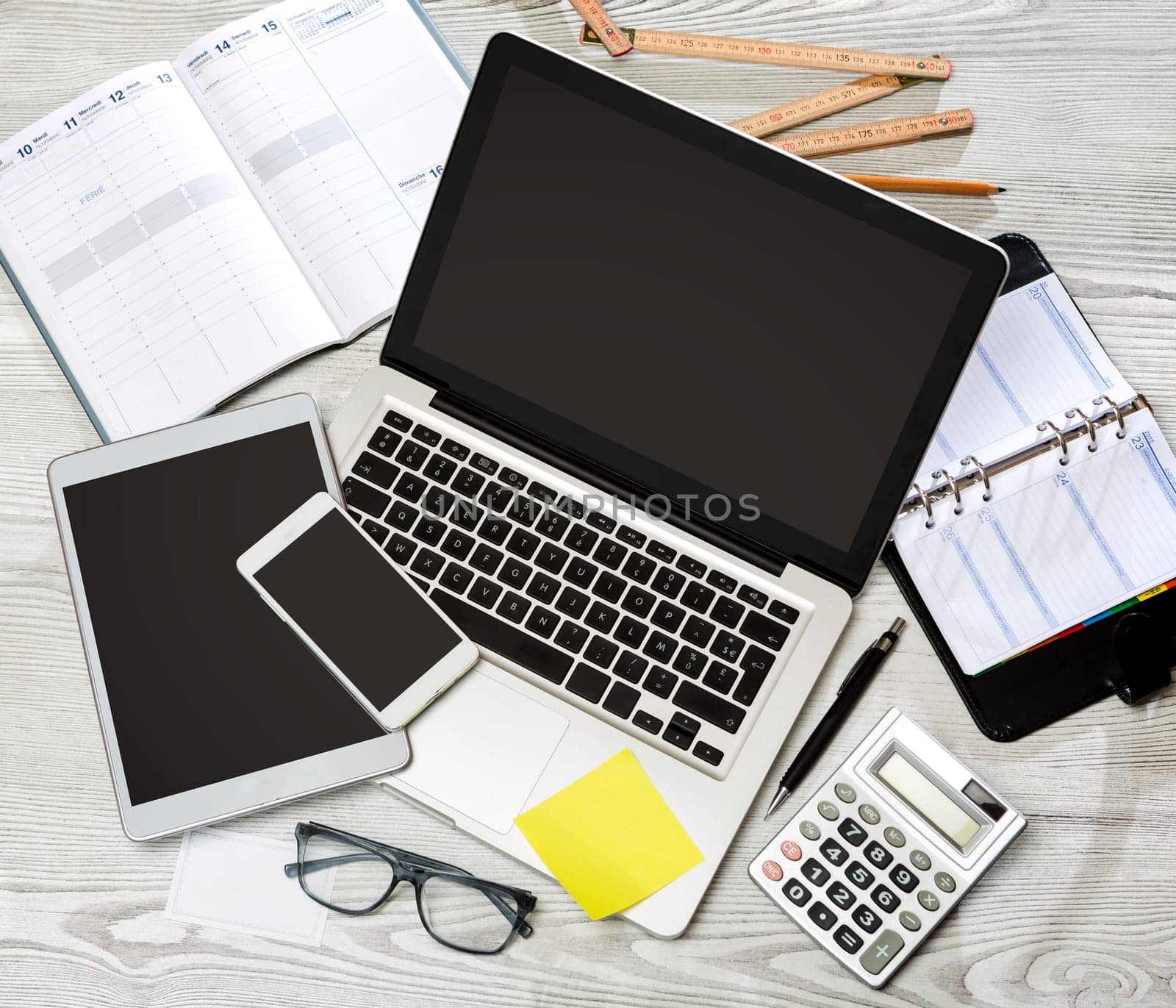 View of a Wood businessman's desk in high definition with laptop, tablet and mobile