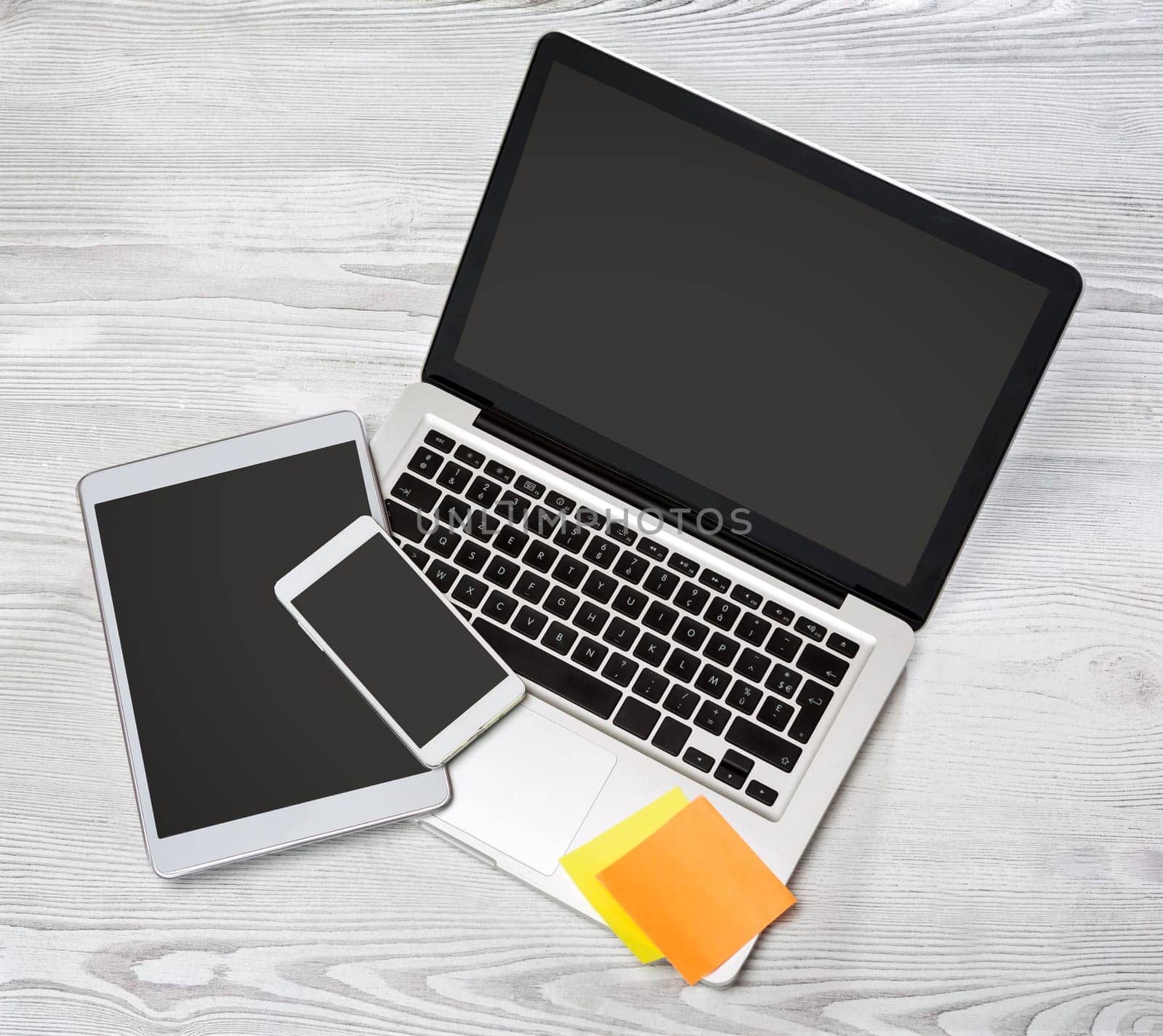 View of a Laptop in high definition with tablet and mobile on a wood background