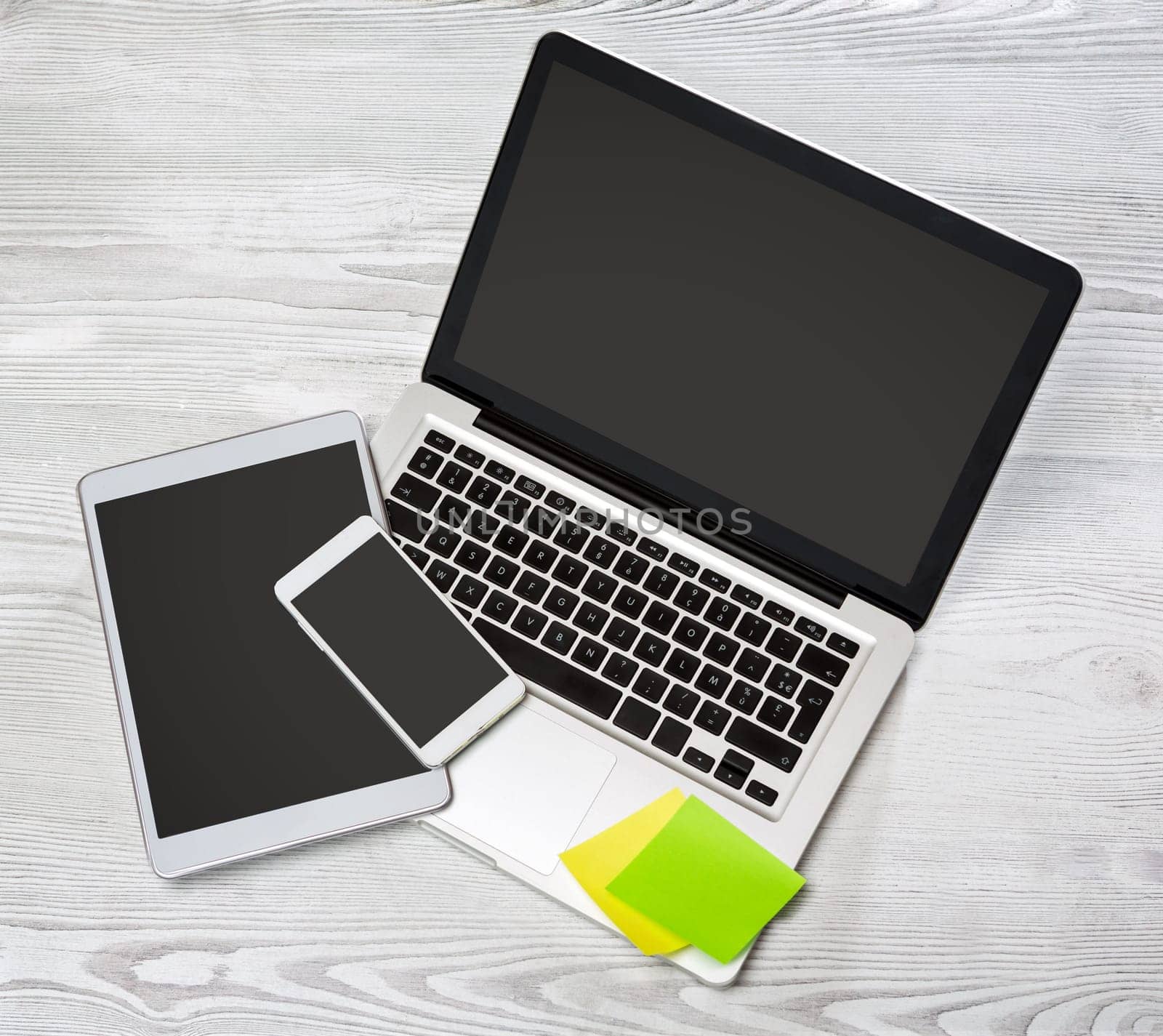 View of a Laptop in high definition with tablet and mobile on a wood background