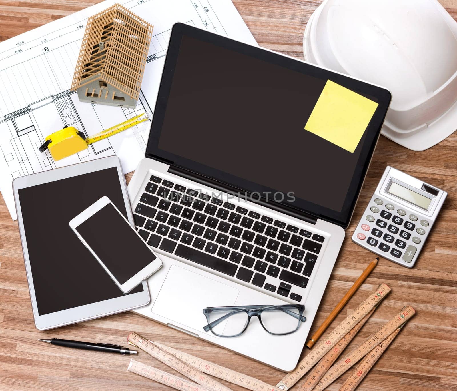 View of a Wood architect's desk in high definition with laptop, tablet and mobile