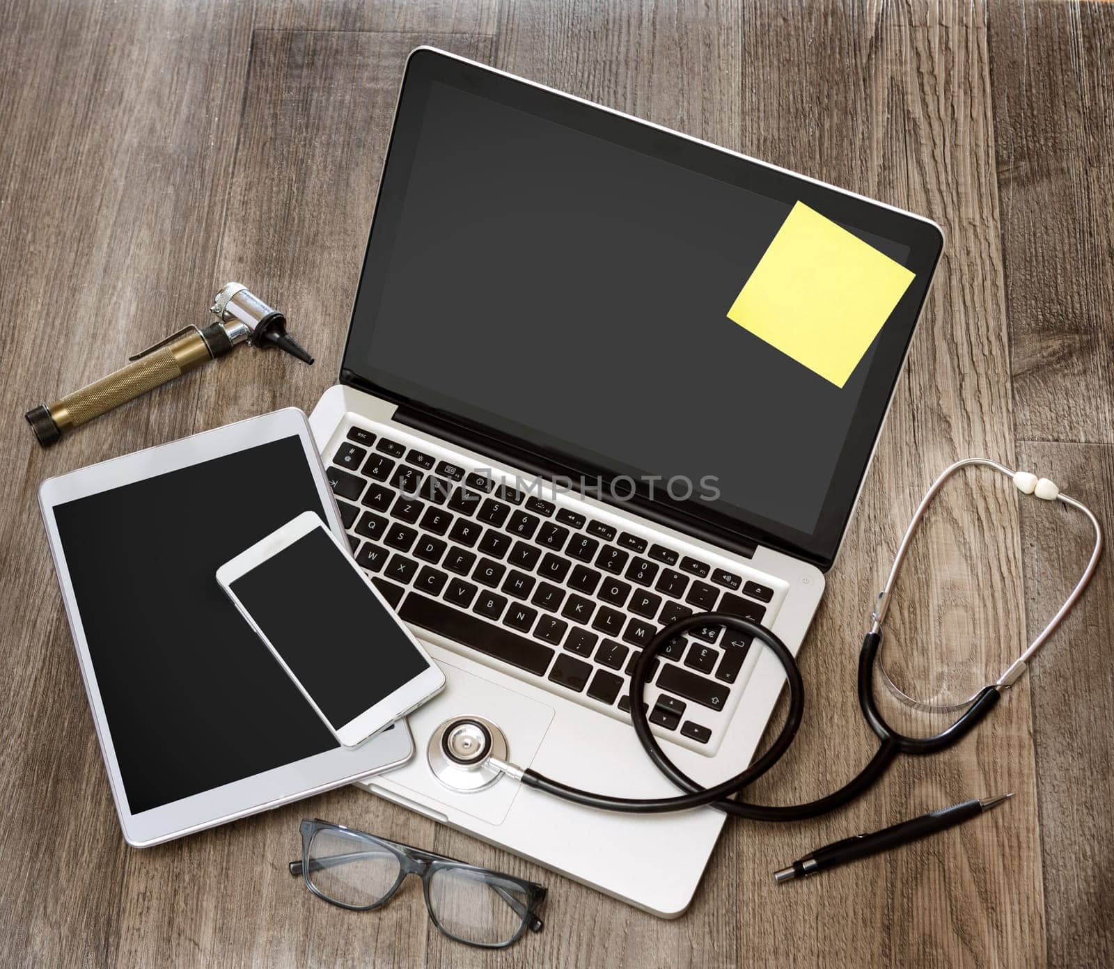 View of a Wood doctor's desk in high definition with laptop, tablet and mobile phone