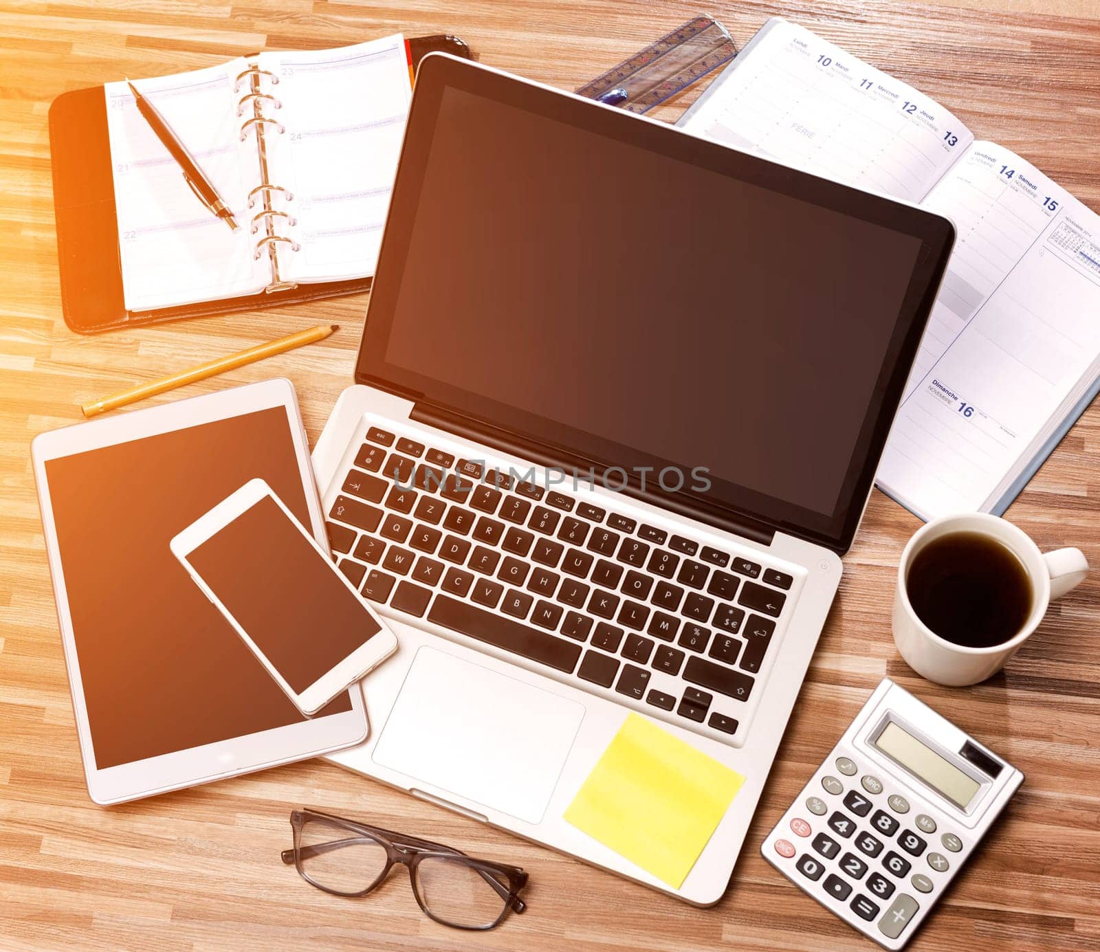 View of a Wood businessman's desk in high definition with laptop, tablet and mobile