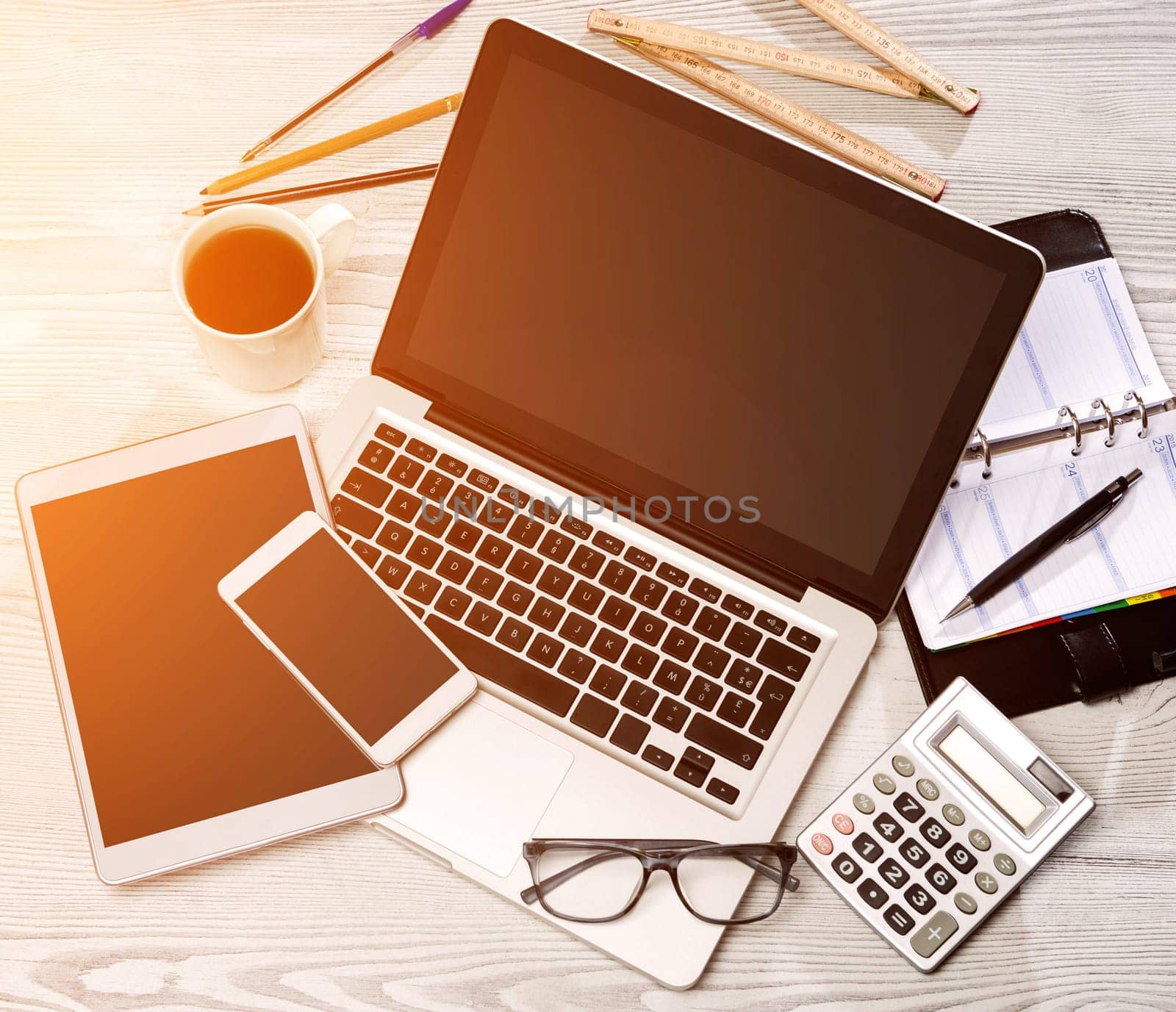View of a Wood businessman's desk in high definition with laptop, tablet and mobile