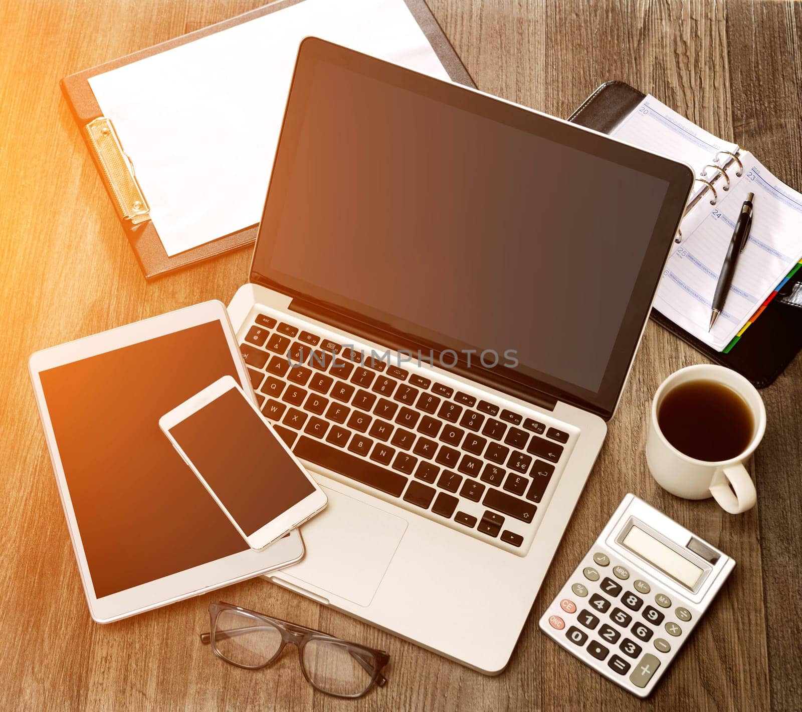 View of a Wood businessman's desk in high definition with laptop, tablet and mobile