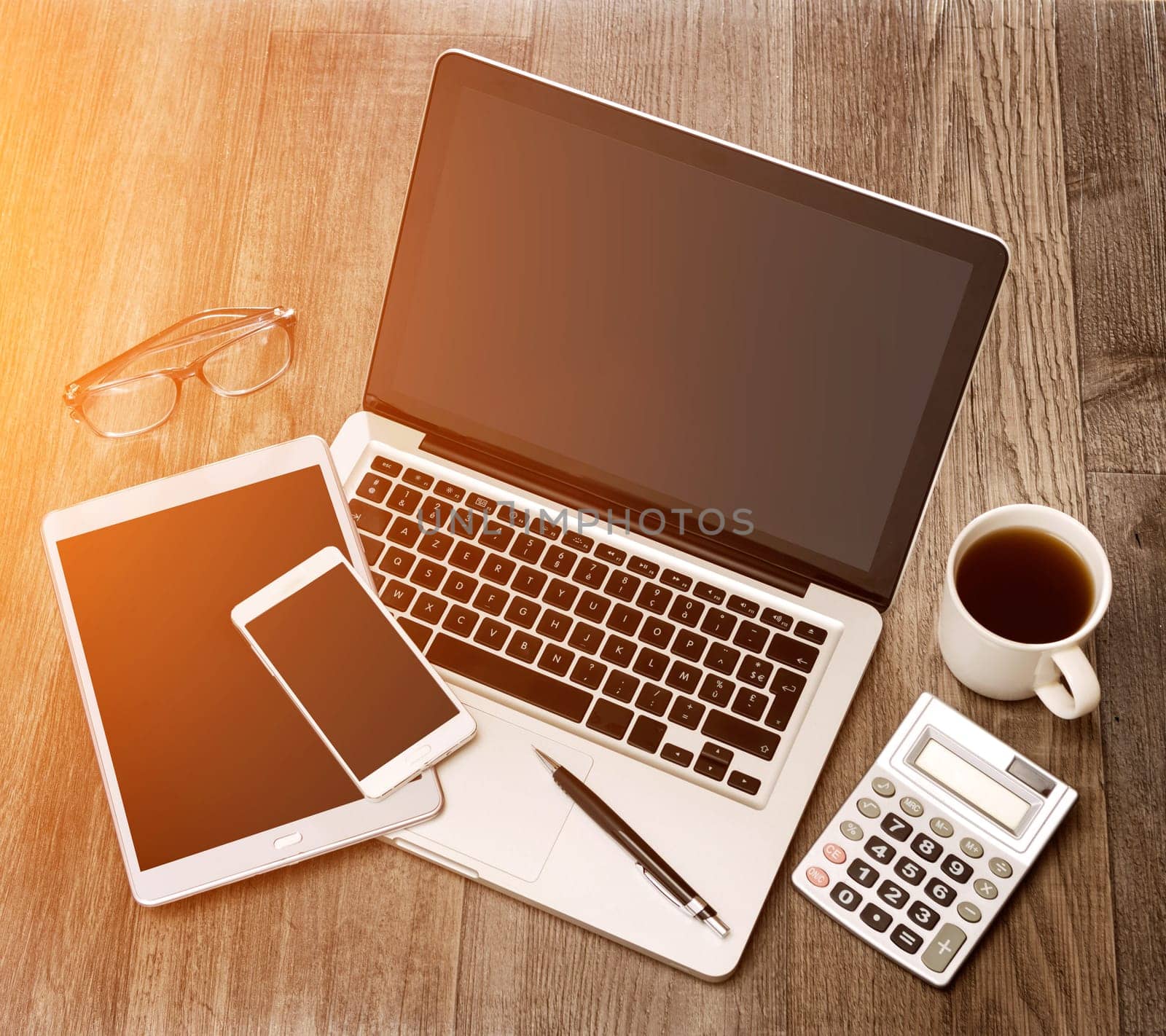 View of a Wood businessman's desk in high definition with laptop, tablet and mobile