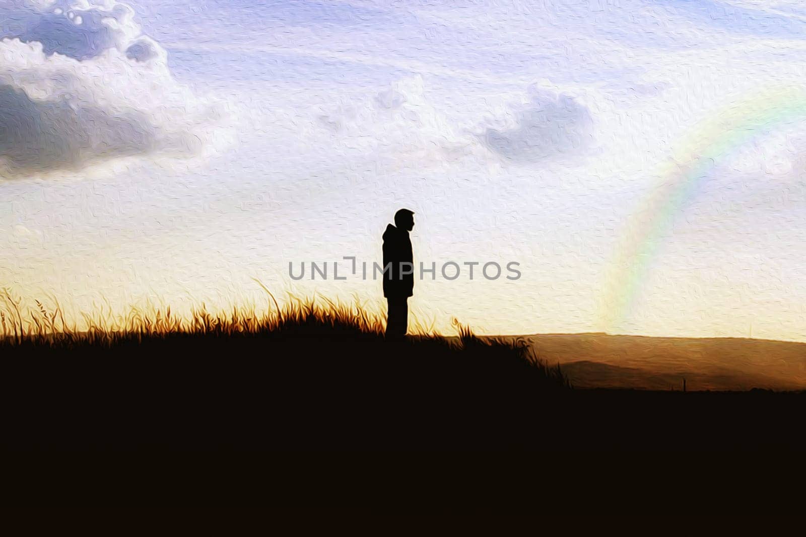 Boy standing on top of a hill over the rainbow