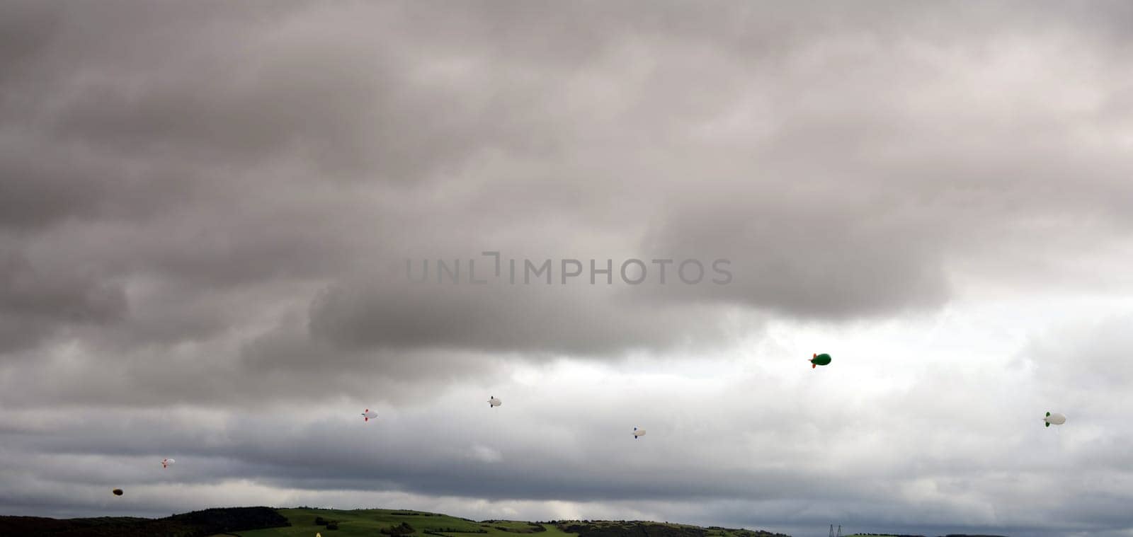 clouds full of air blimps high in the grey sky
