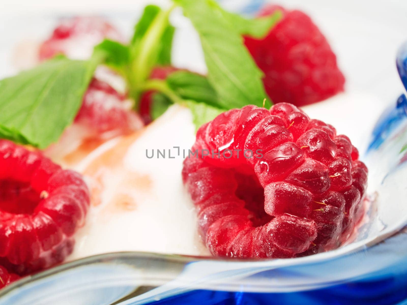 Vanilla ice cream with raspberries, close up