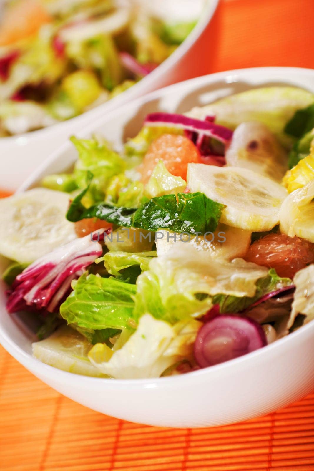 Salad with lettuce, cucumbers and grapefruit, close up