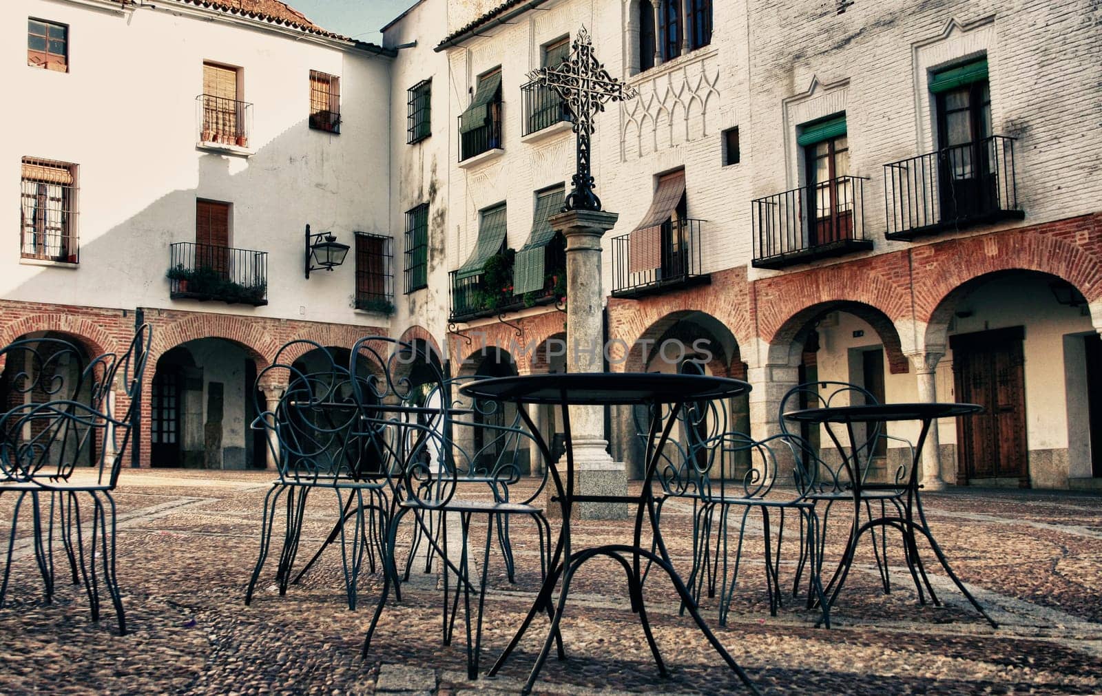Plaza Chica, Small square of Zafra with pedestal tables, Badajoz, Spain. Vintage filtered