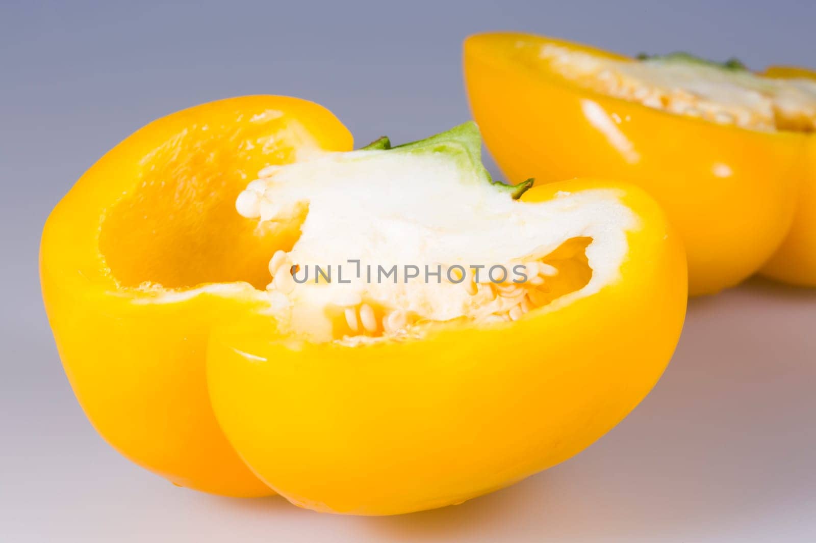 Sliced Yellow Bell Pepper close up on grey background.