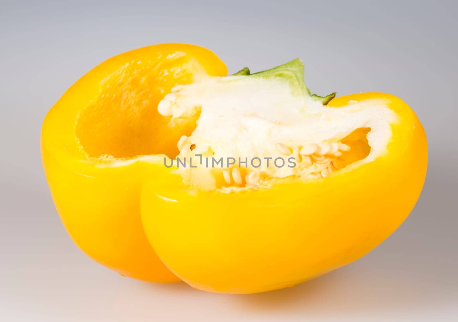 Sliced Yellow Bell Pepper close up on grey background.