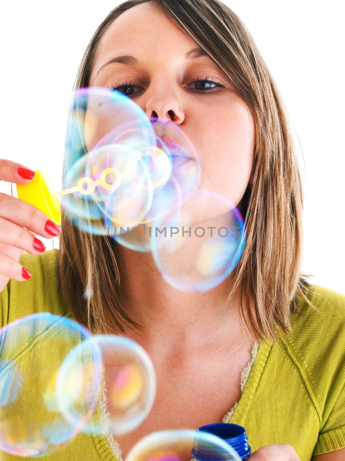 Girl blowing bubbles, isolated on white