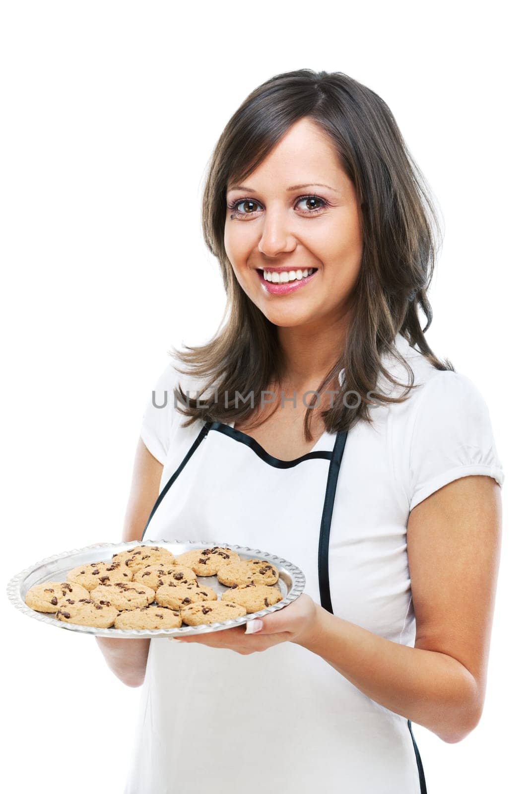 Young woman holding a tray with homemade chocolate cookies, looking at camera