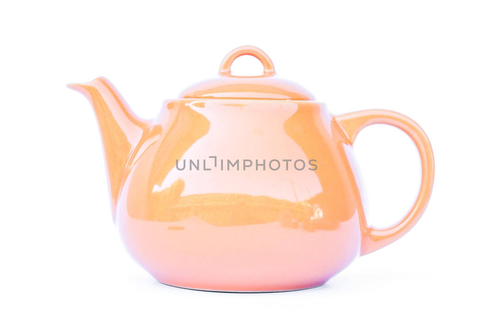Orange ceramic teapot isolated on white background, stock photo