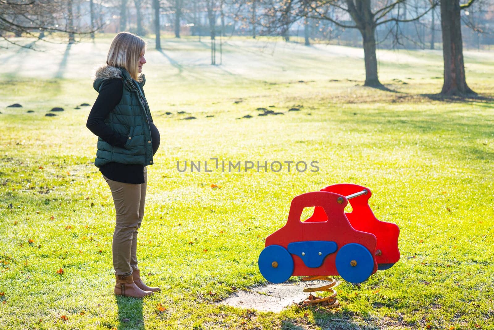 young blond pregnant woman alone the park