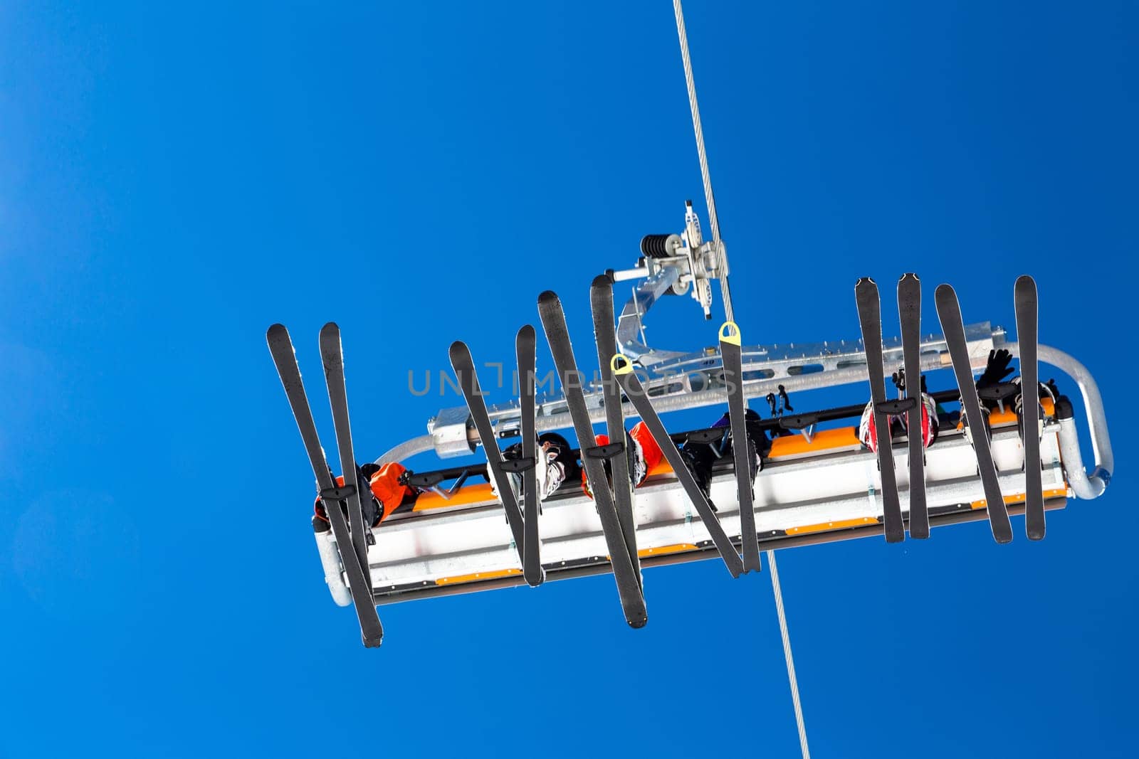 Skiers in a ski lift passing in the air