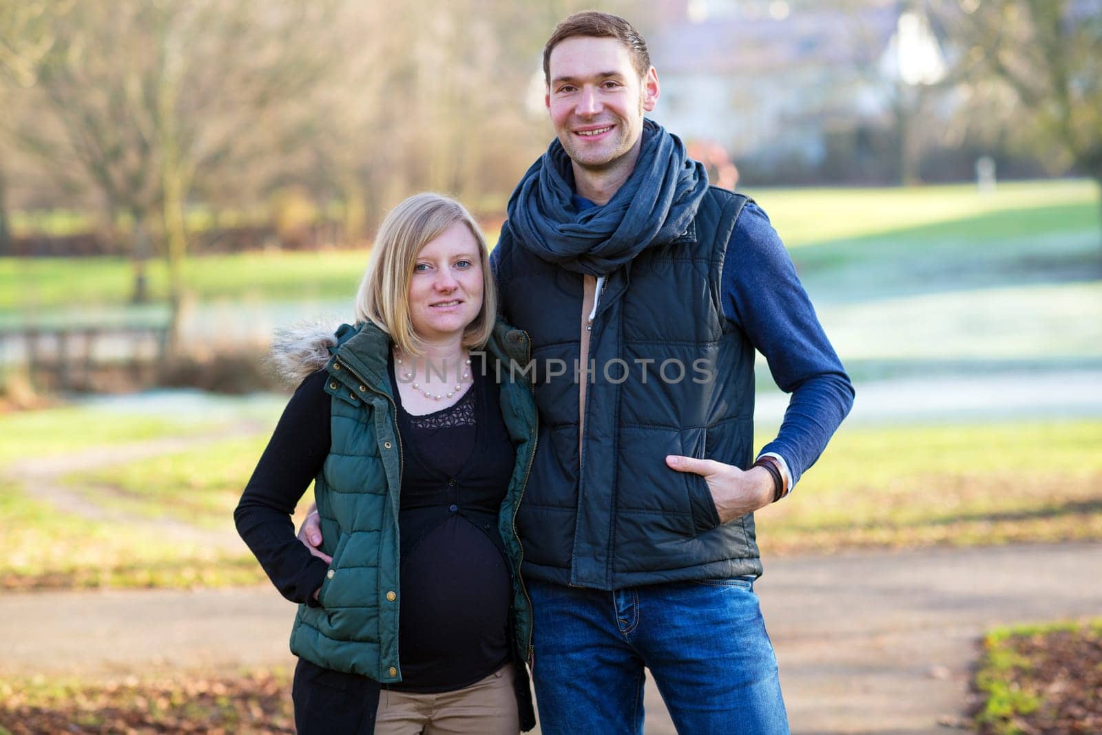young pregnant woman with her husband in the park