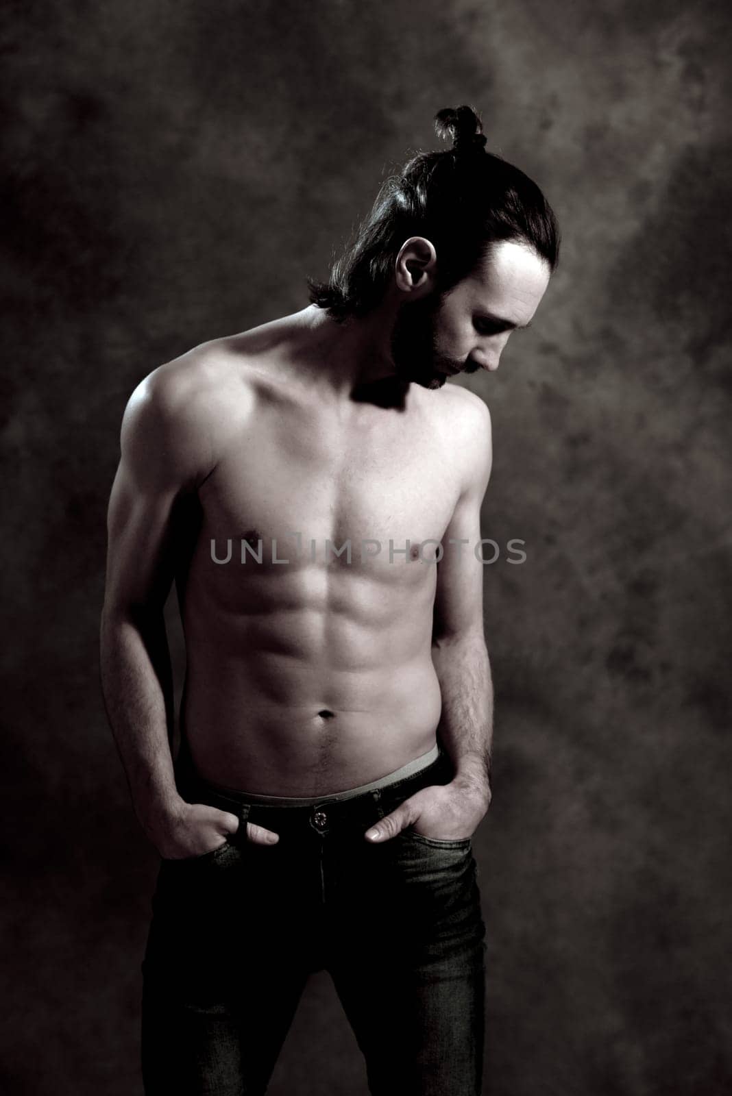 young white man exercised body in front of gray background