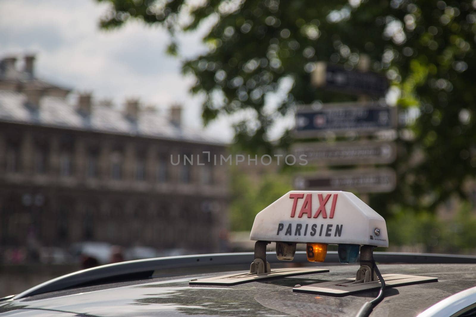 The Taxi sign on top of the roof of the cab in Paris