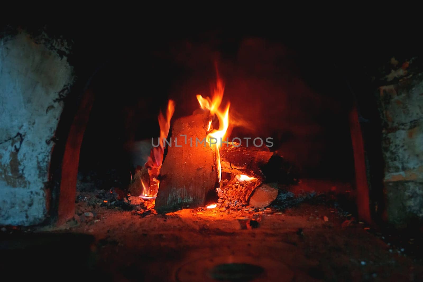 Firewood burn in the stove. Rural background with fire flames.