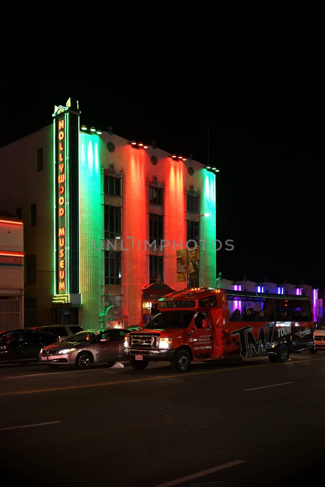 Los Angeles,United States - December 27,2015: A city tour bus passes the nightly illuminated Hollywood Museum toward the famous Hollywood Boulevard on December 27,2015 in Los Angeles.