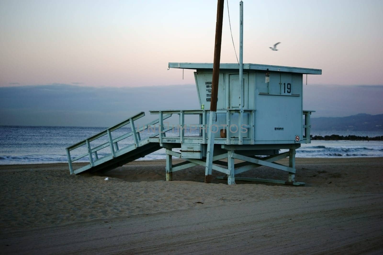A lifeguard's watchhouse during a sunrise on Venice Beach.