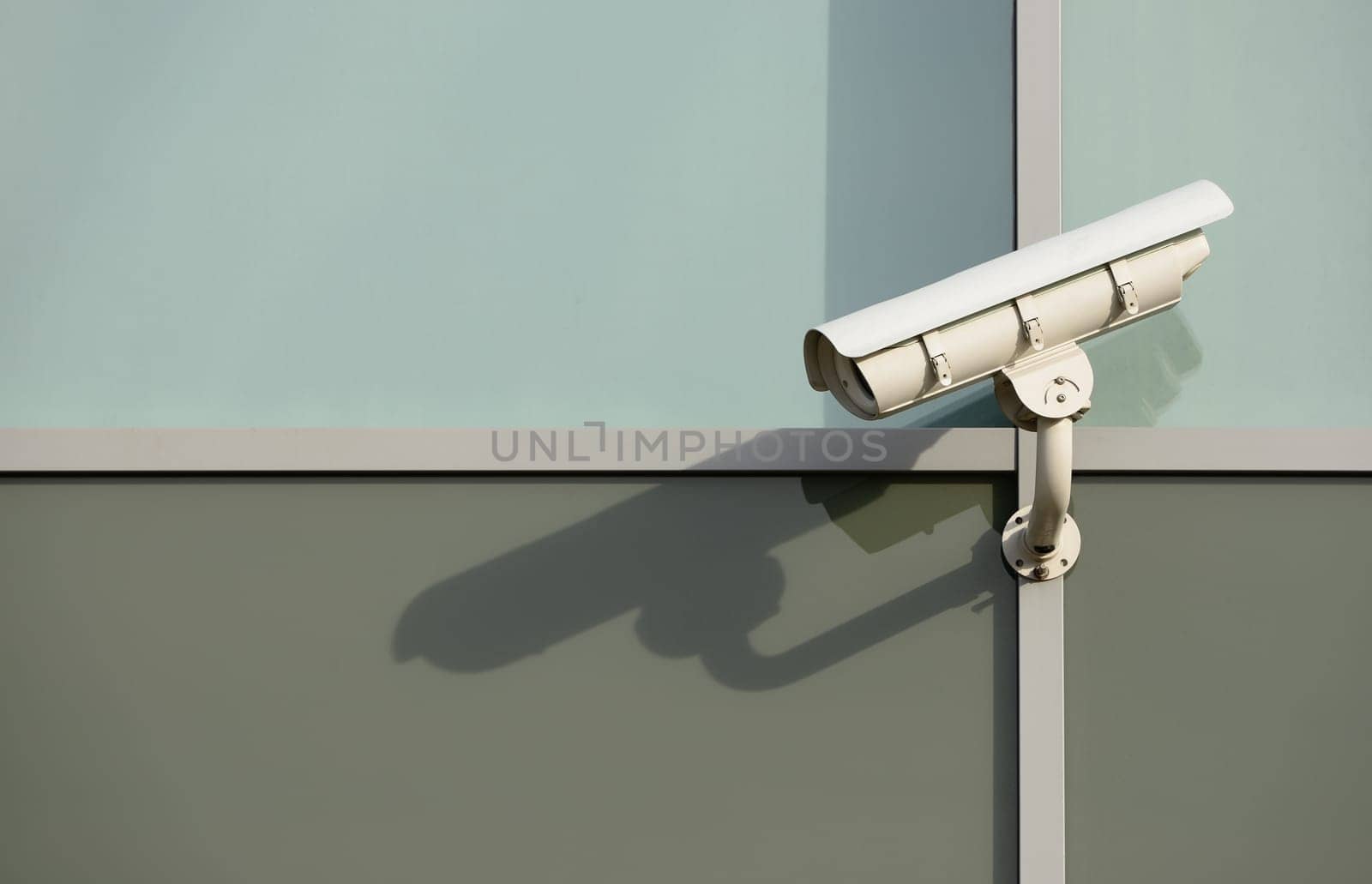 White generic security camera on modern building.