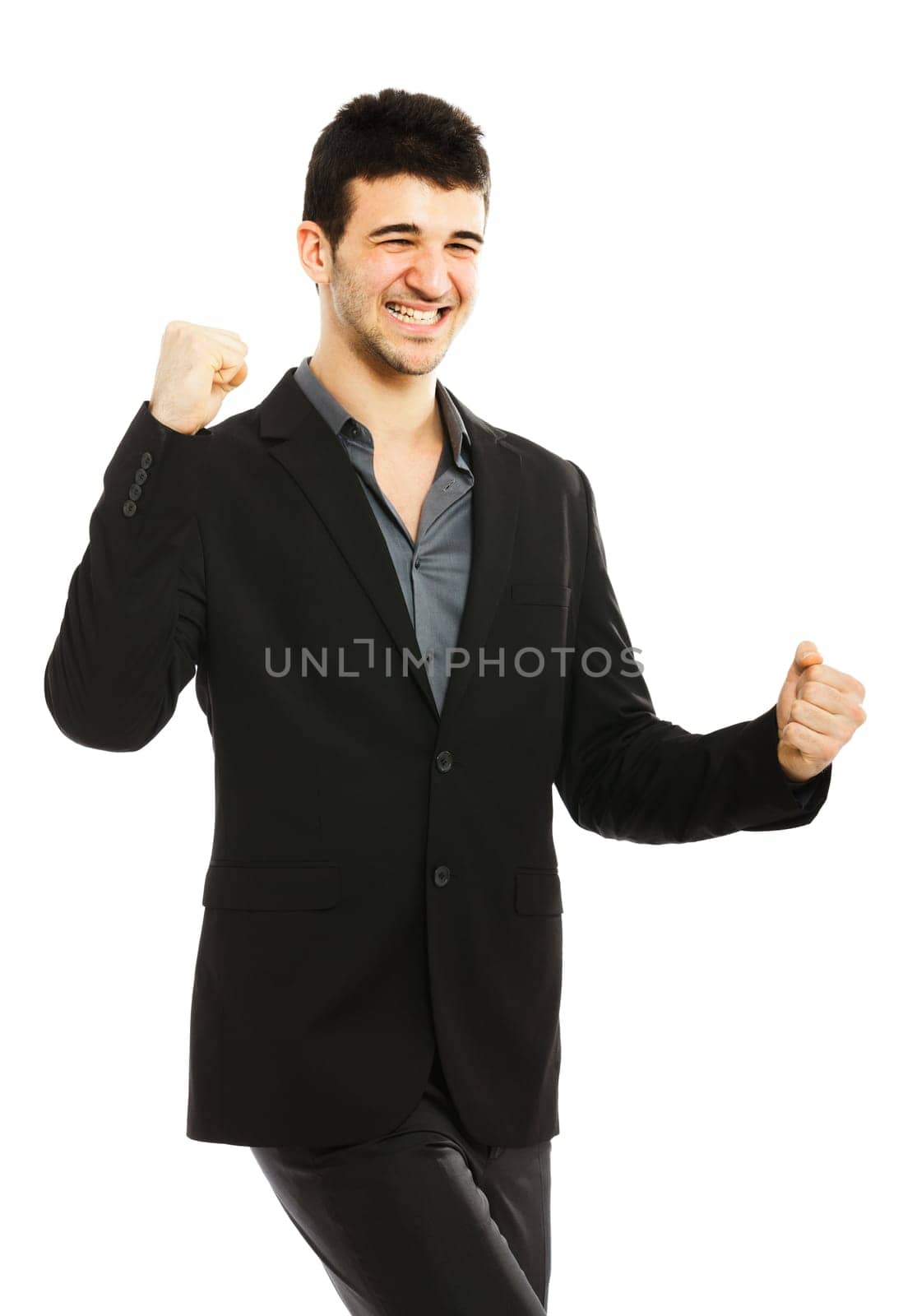 Young businessman punching the air isolated on white background