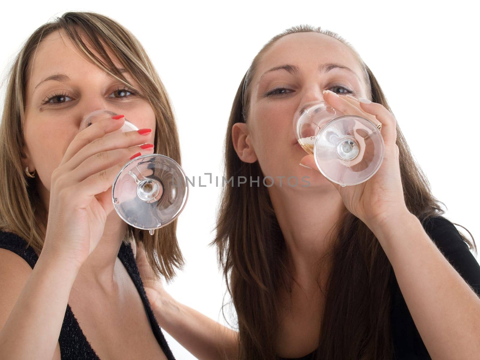 Girls celebrating with champagne isolated on white