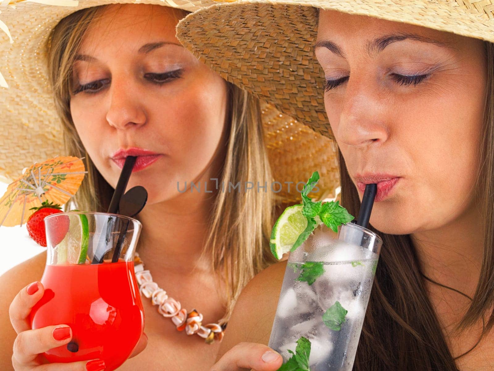 Close up of girls with mojito and tropical drink