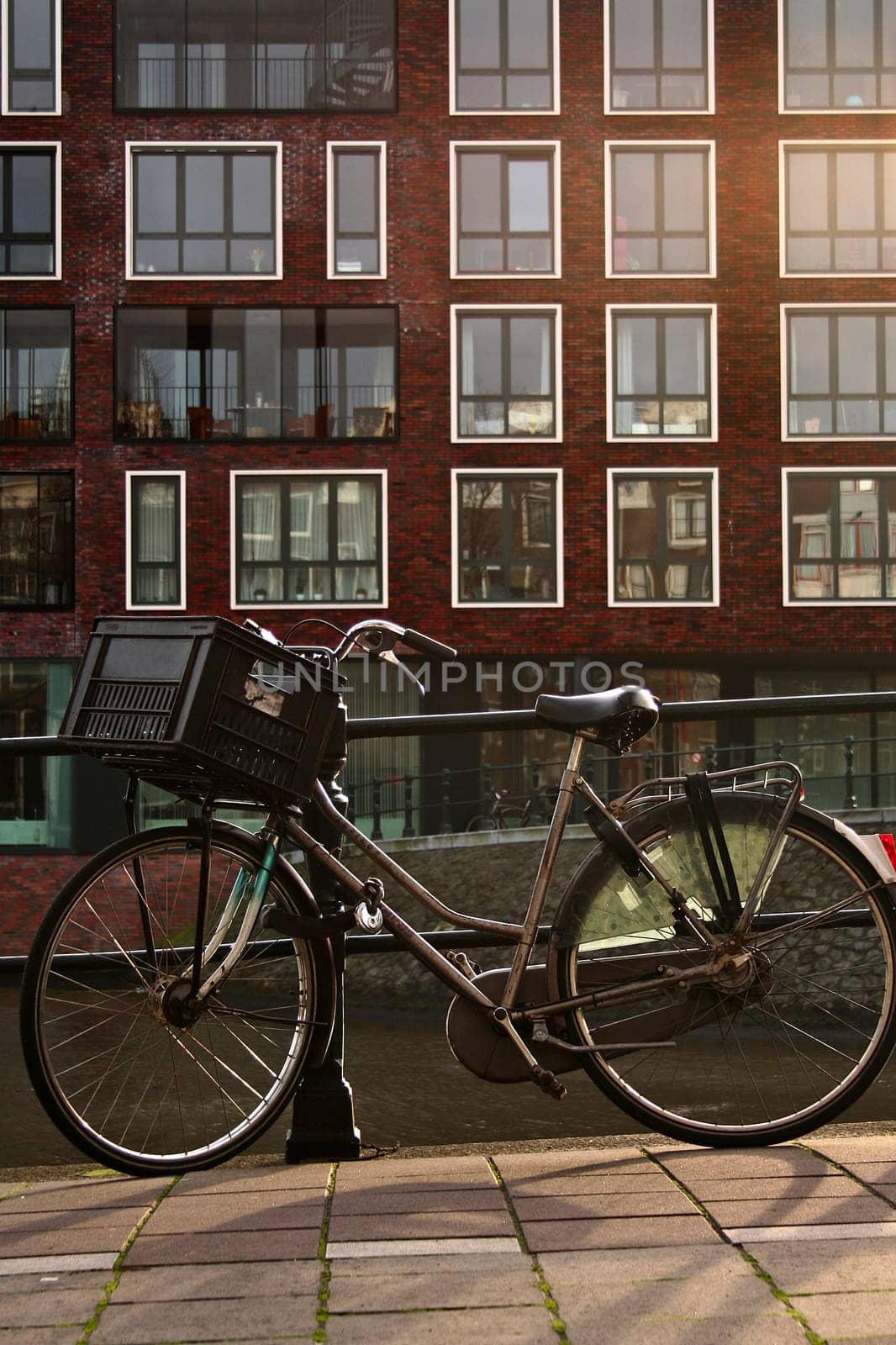 Iconic commuter bicycle resting on the handrail of a canal