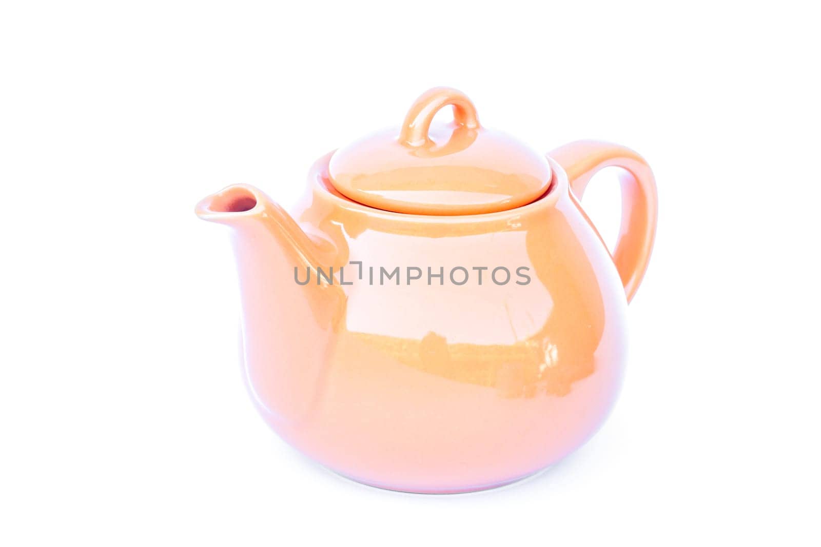 Orange ceramic teapot isolated on white background, stock photo
