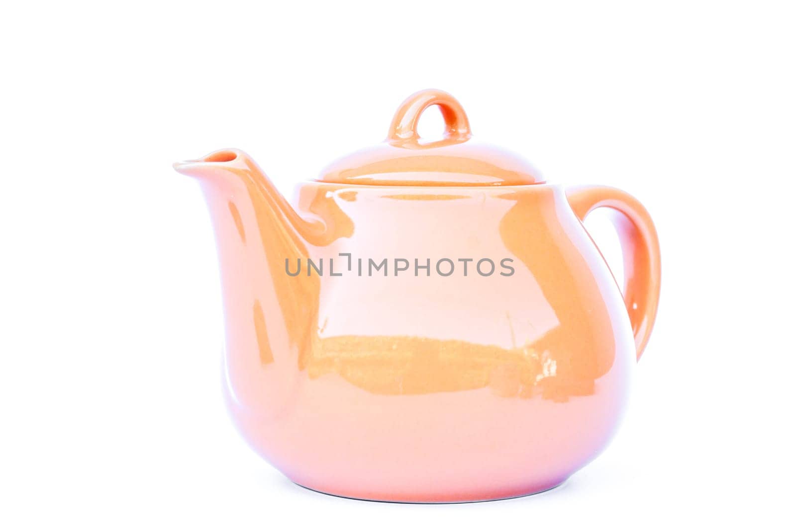 Orange ceramic teapot isolated on white background, stock photo