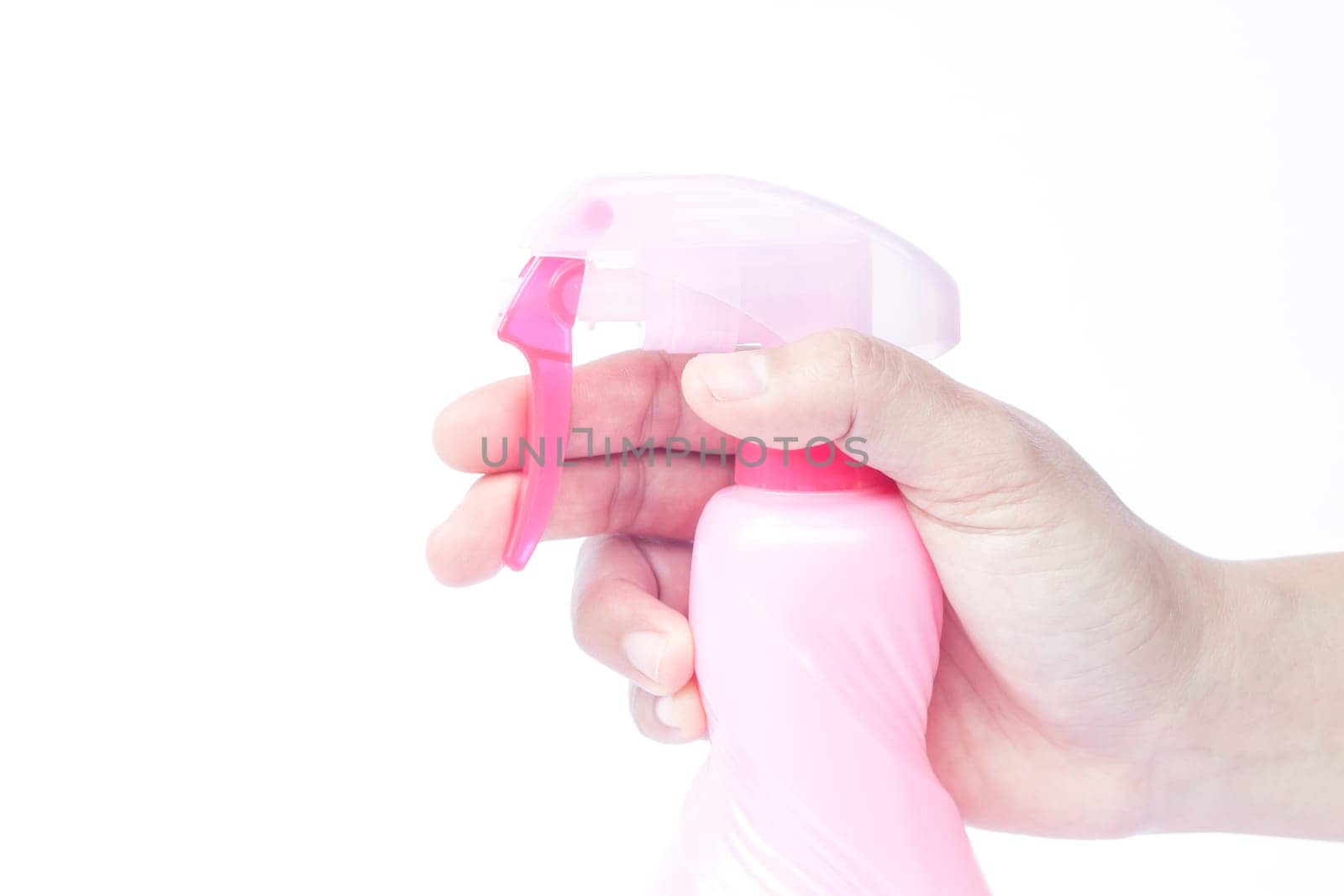 Hand holding plastic foggy spray bottle isolated on white background, stock photo