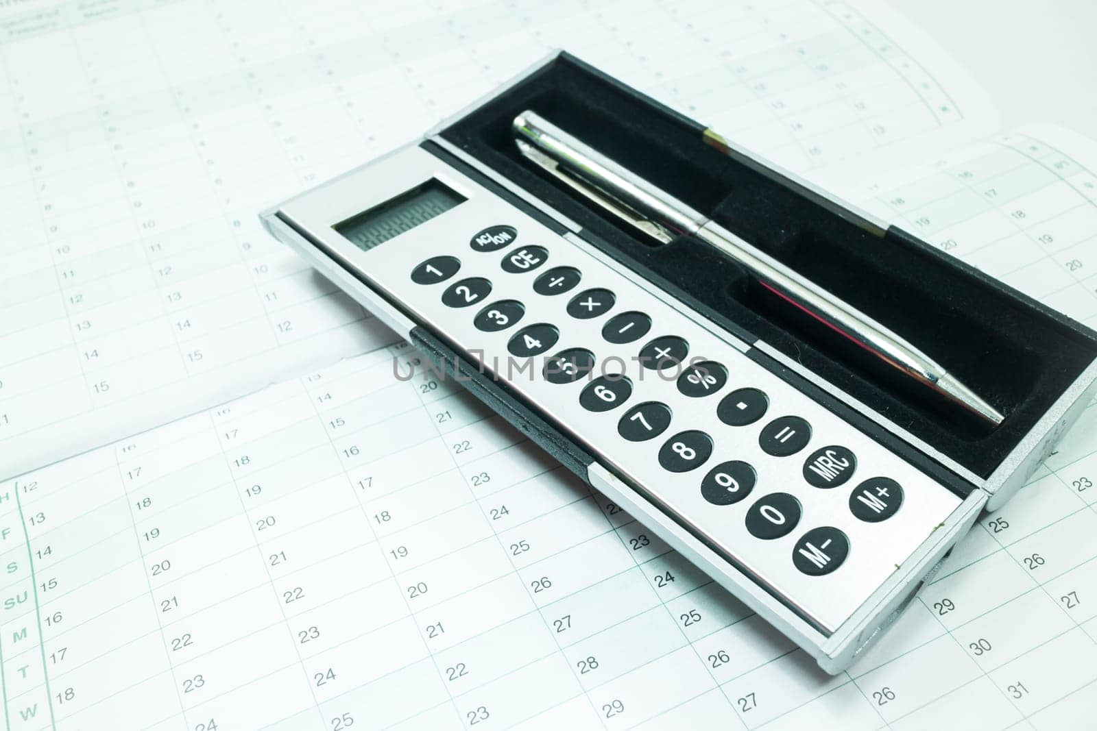 Pocket calculator and pen on the table, stock photo
