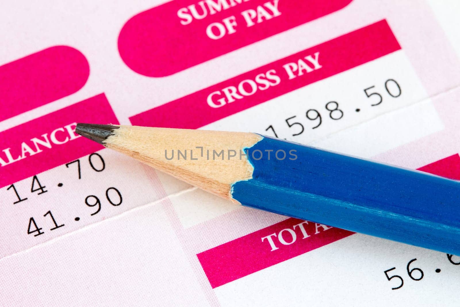 Close up of pencil and wage slip