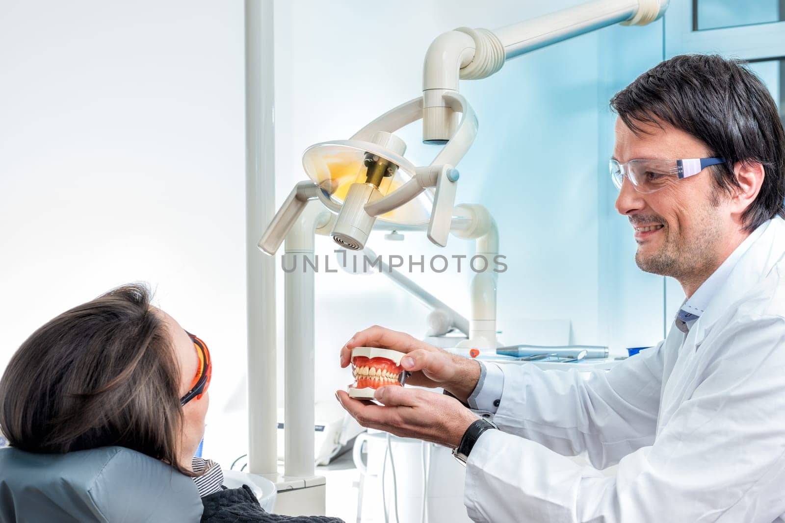 young dentist advises a customer