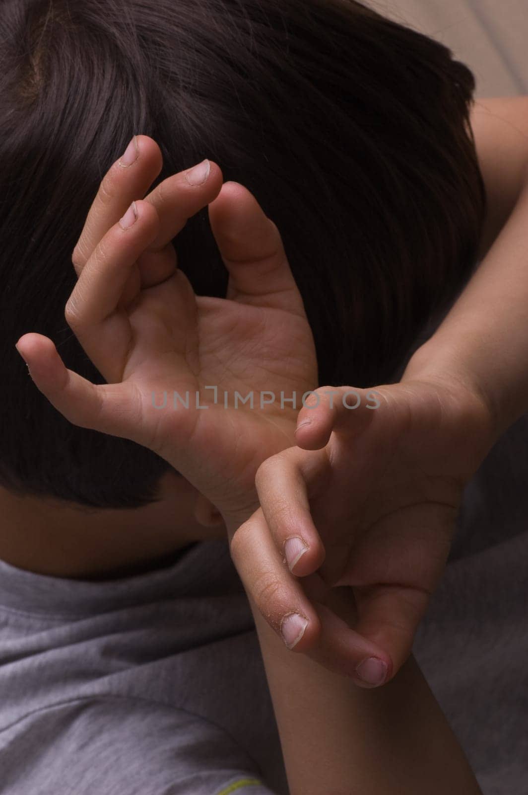 Child raising hands to protect itself