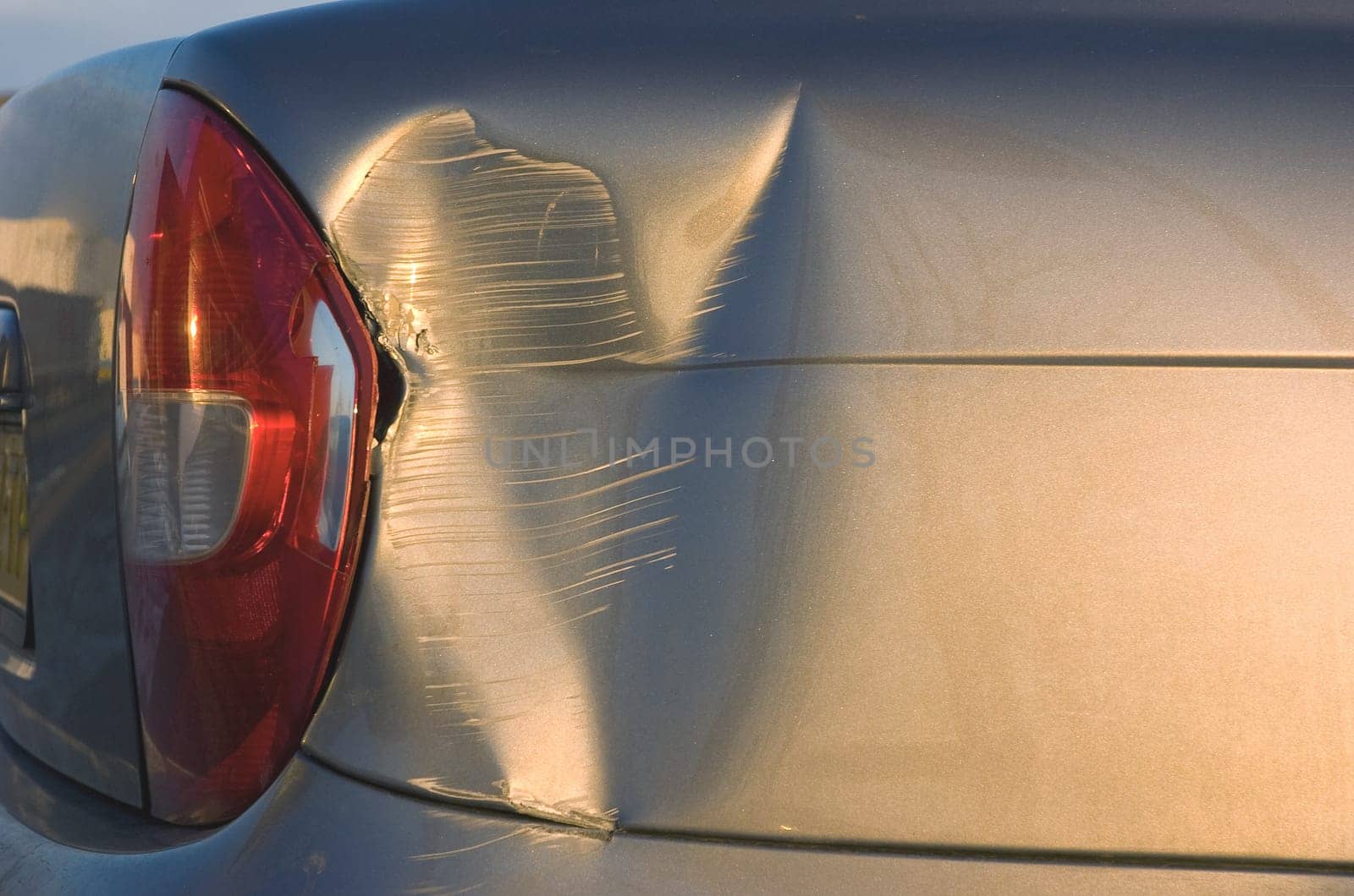 A dent in the right front quarter of a european car