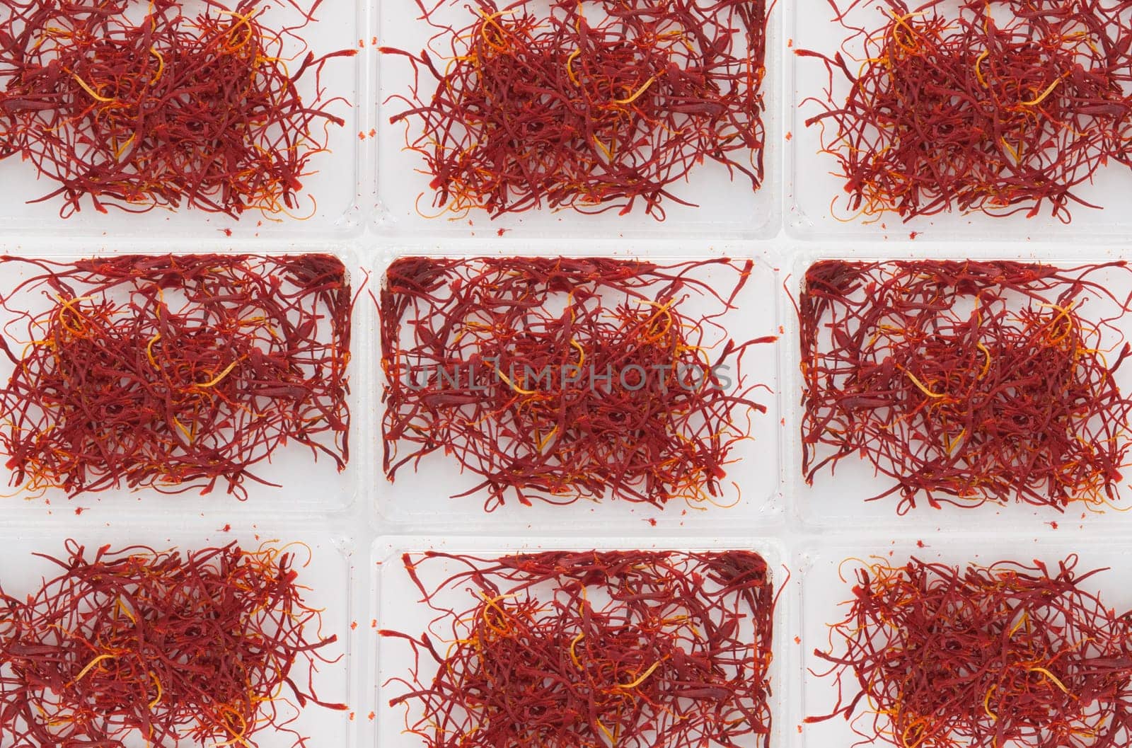 6 little plastic boxes of spanish Saffron Isolated on white background