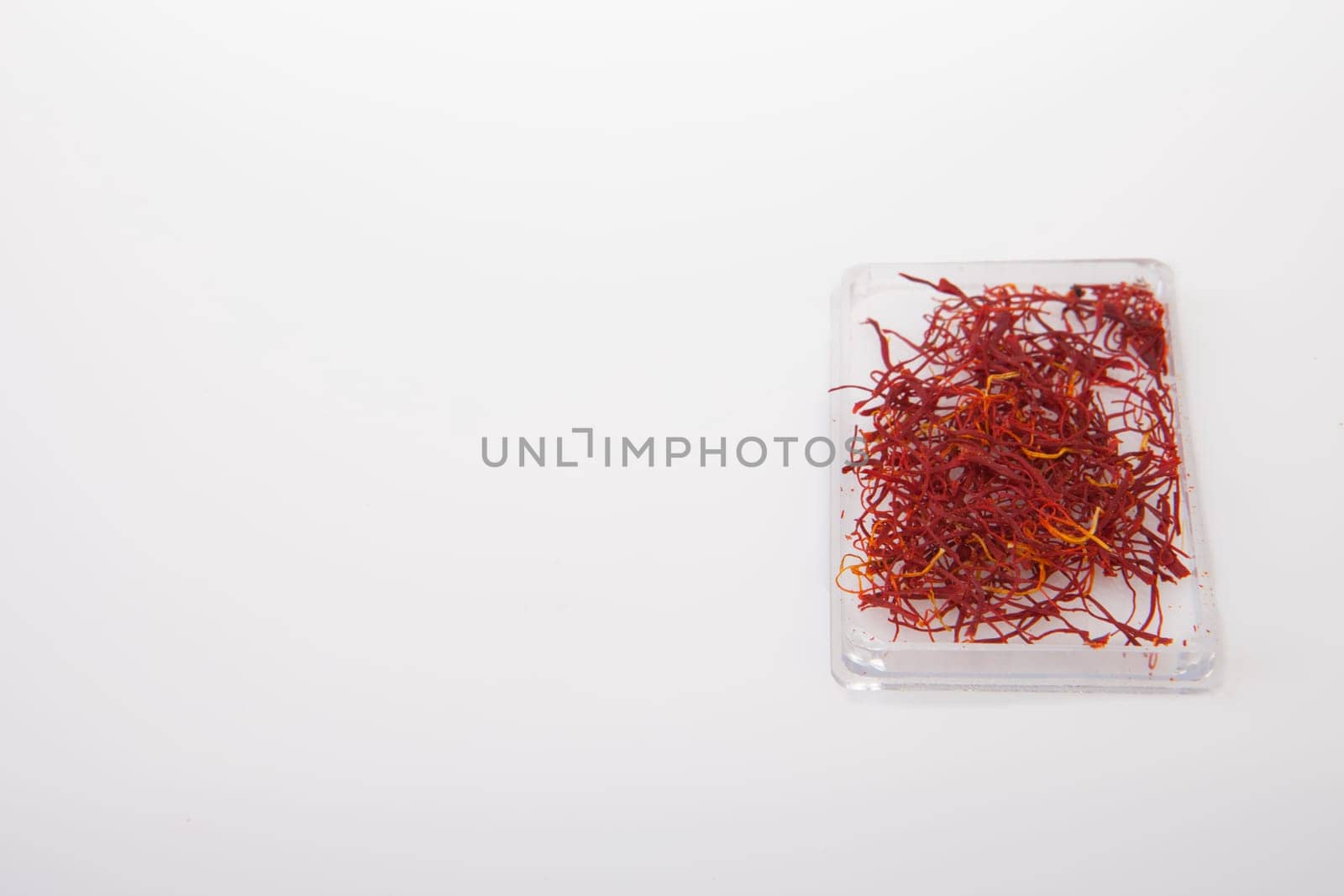 Little plastic box of spanish Saffron Isolated on white background