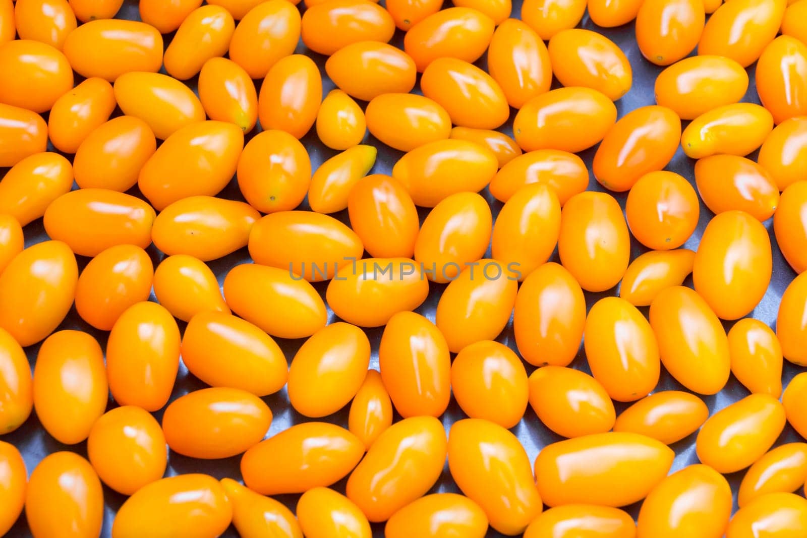 Photo of background with fresh yellow tomatos