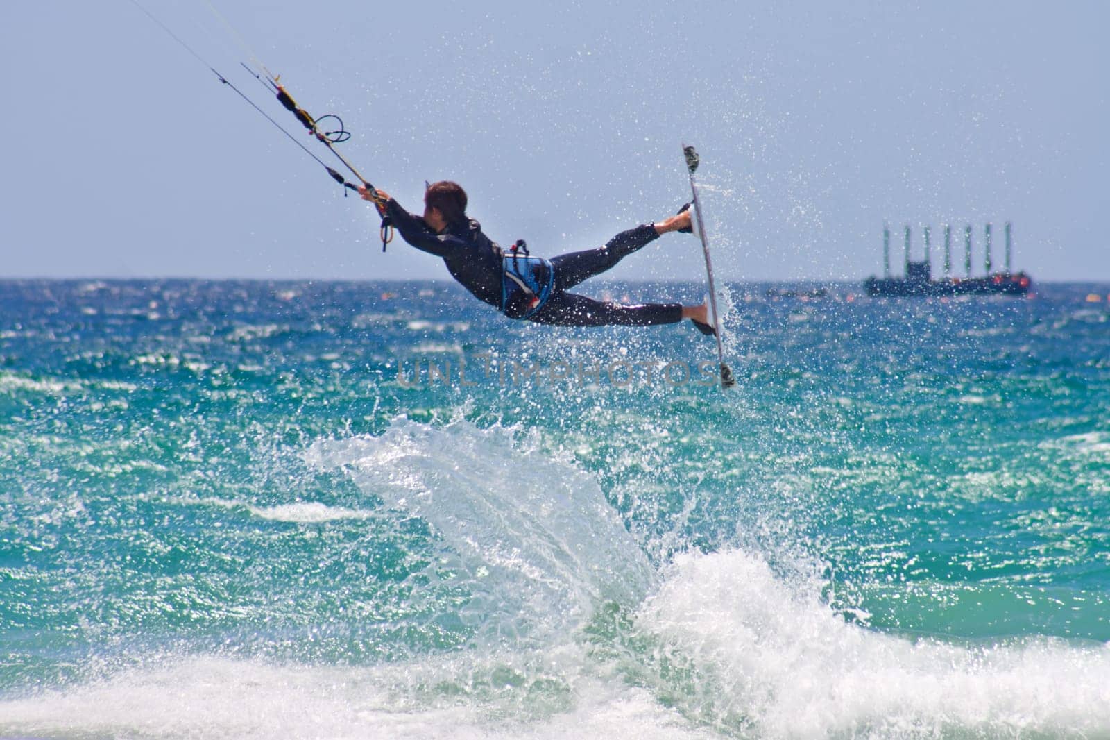 Unidentified sportsman kite surfer jumping in Tarifa, Spain