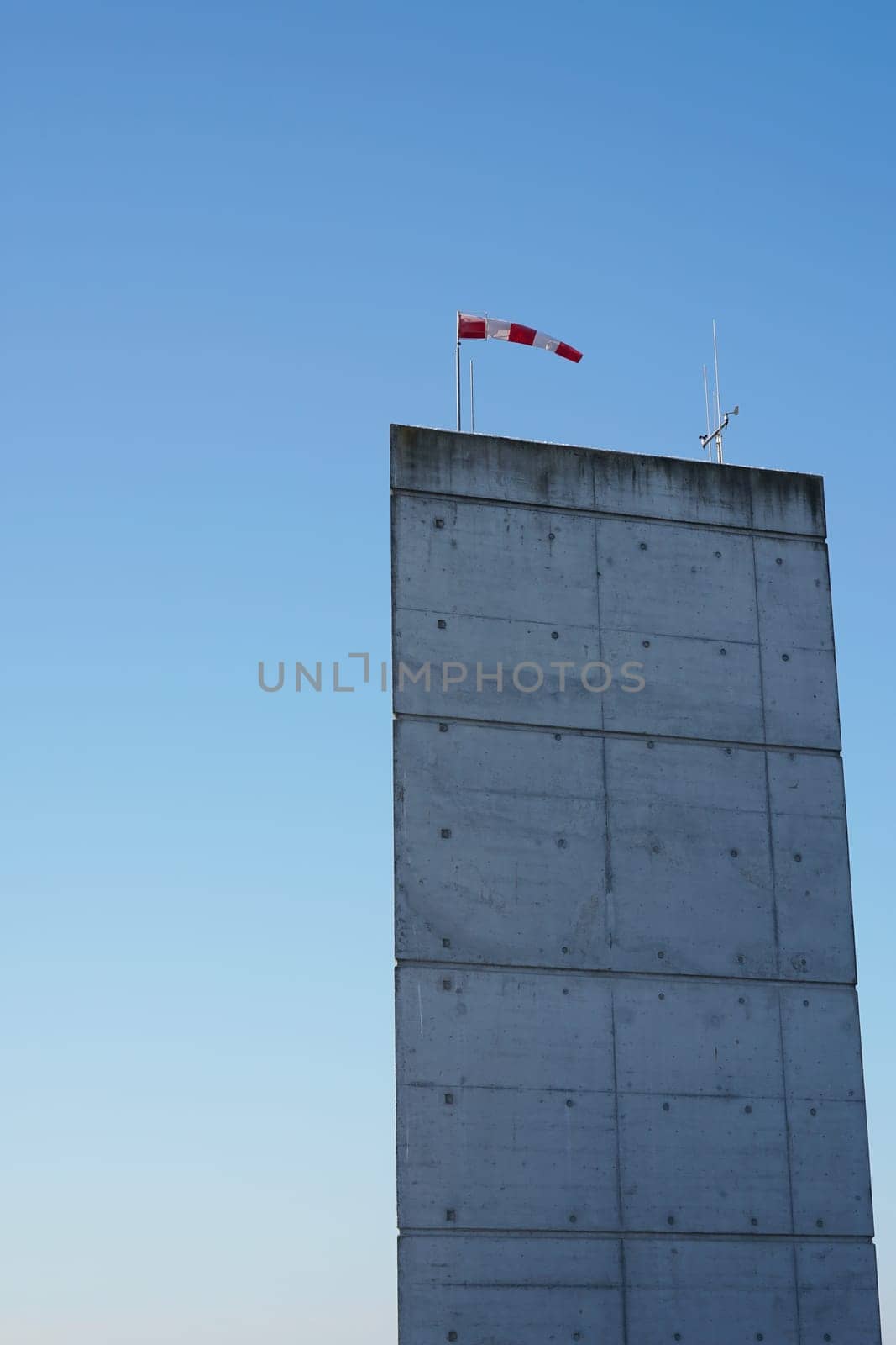 Wind vane on a concrete pillar