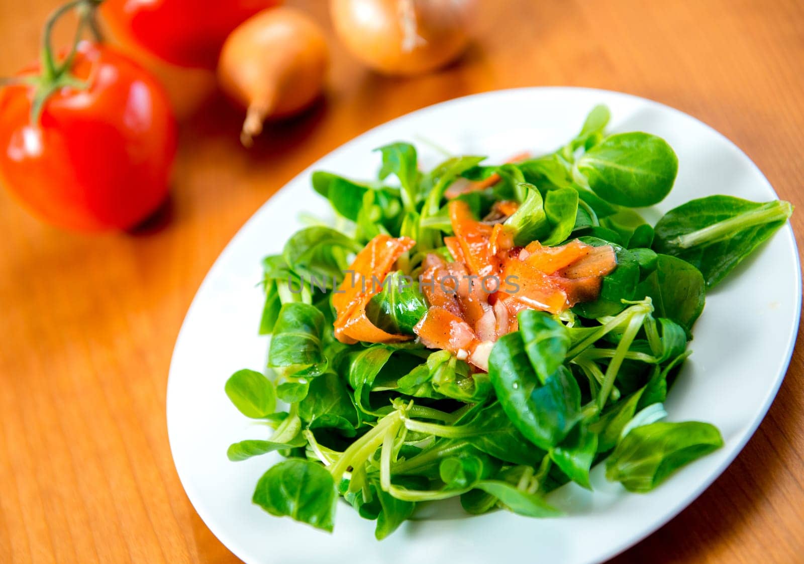 fresh field salad with carrot, tomato and onion