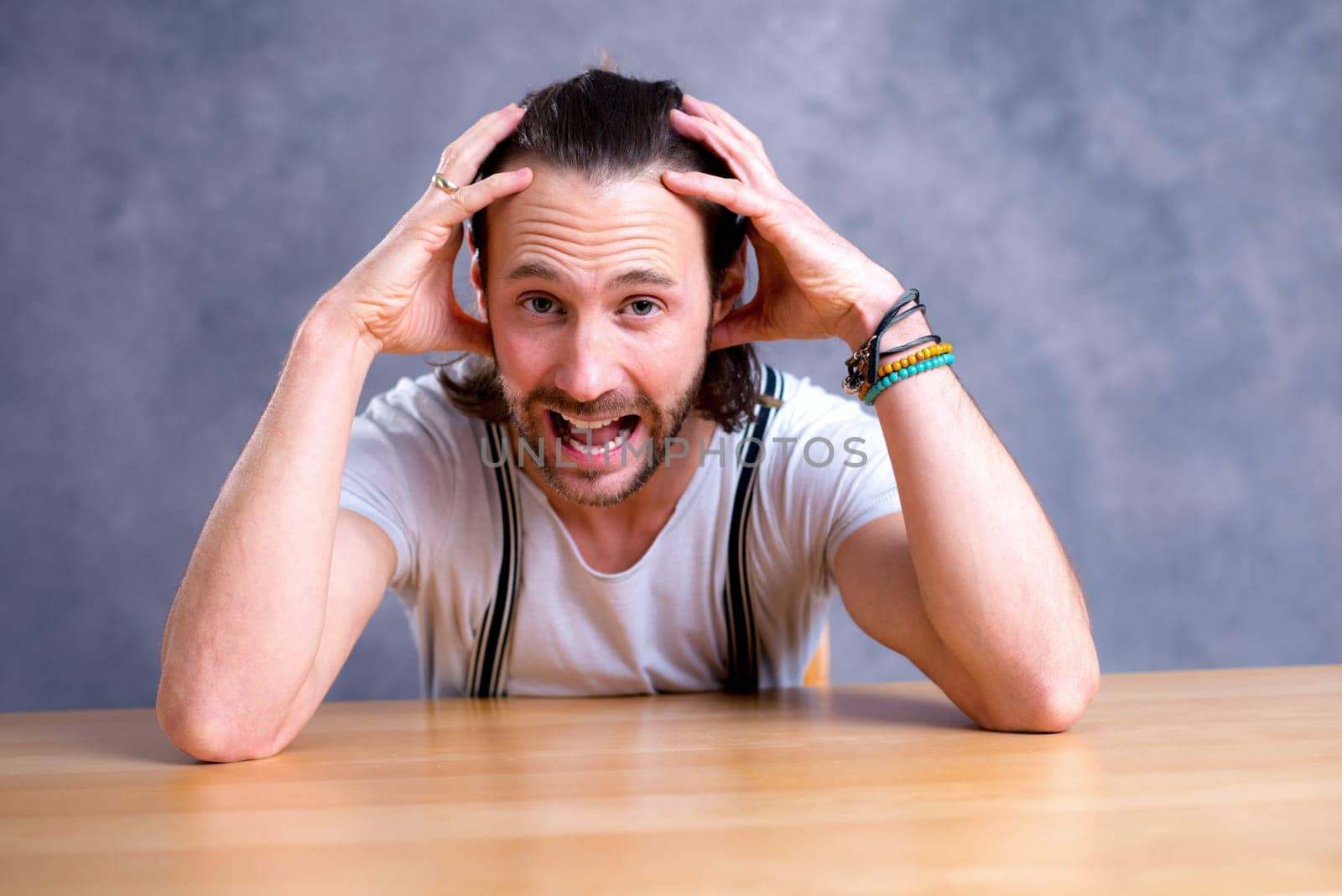 young bearded man lokking shocked in to the camera