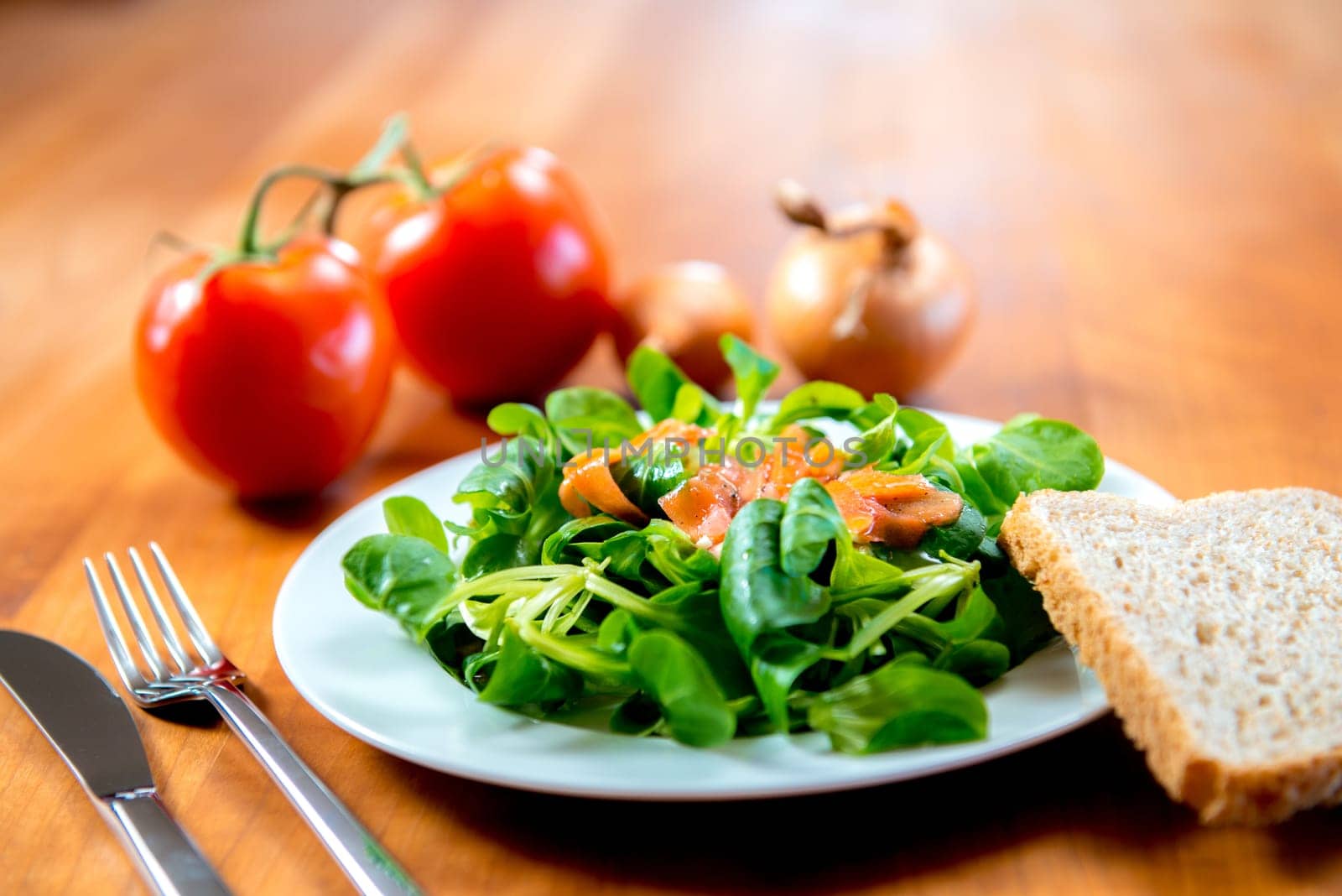fresh field salad with carrot, tomato onion and bread