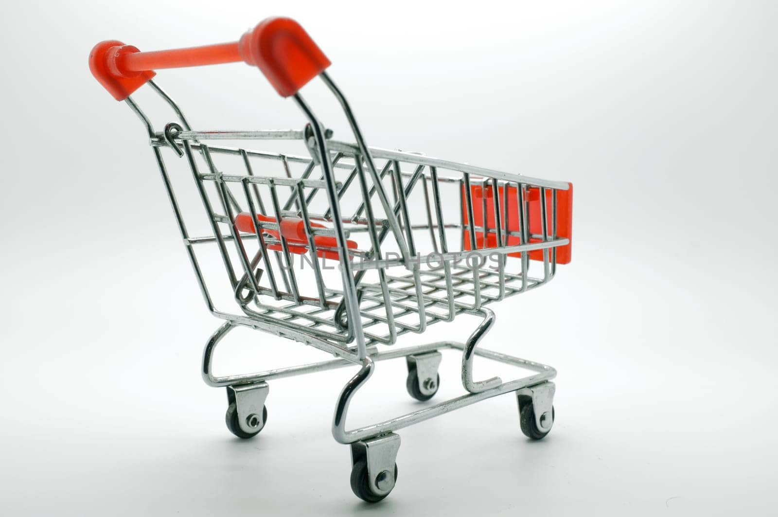 Empty shopping cart, side view, on white background